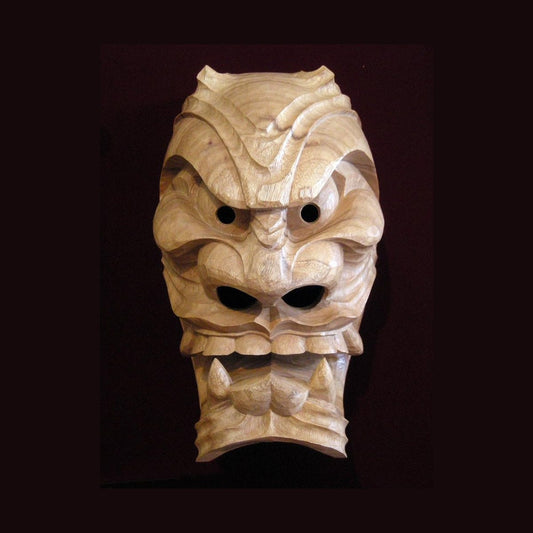 The "a" furyu mask in plain camphor: mouth open with fangs and tongue, upswept eyes, short horns