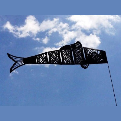 Black Koinobori carp streamer against the sky