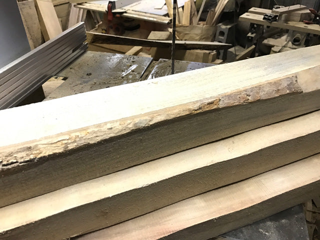 Sawn camphor boards stacked to dry in the workshop