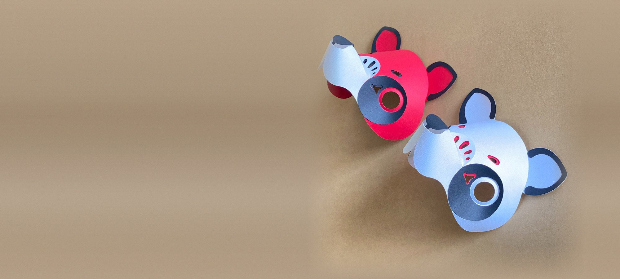 Tanuki papercraft masks in red and white on kraft paper