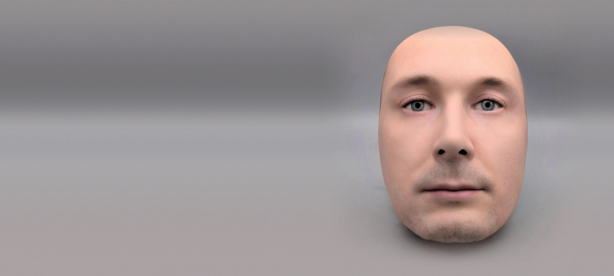 That Face No.03 — hyper-realistic human face mask on a grey studio wall